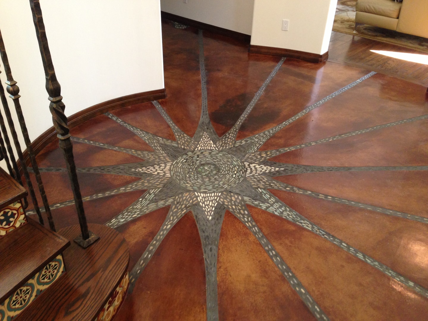Inlaid star floor medallion in stained concrete — Studio City